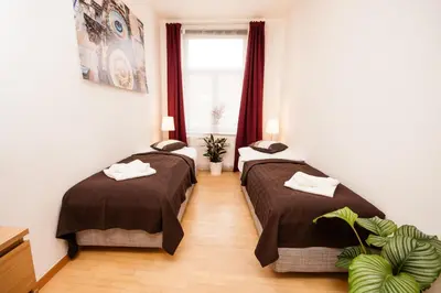 two beds in a room with a window at Wenceslas Square Lofts in Prague