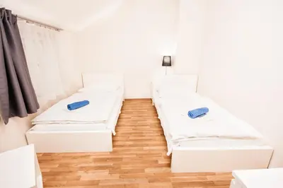 a small bedroom with a white bed and a window at Fashion Loft in Prague