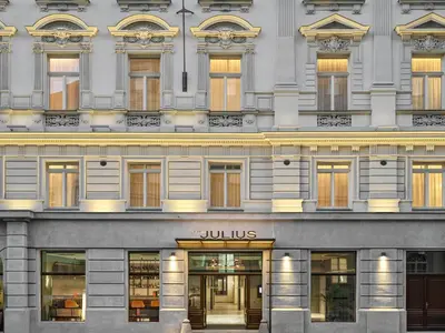 a facade of a building with a julius store at The Julius Prague in Prague