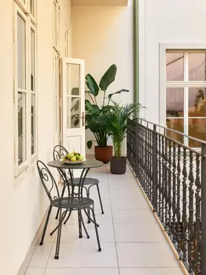 a patio with a table and chairs on a balcony at The Julius Prague in Prague