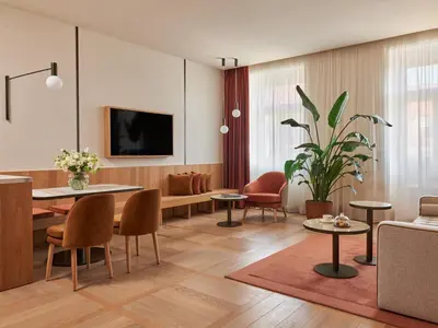 a living room with a couch and a table and chairs at The Julius Prague in Prague