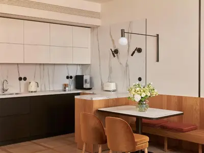 a kitchen with a table with a vase of flowers on it at The Julius Prague in Prague