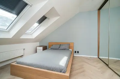 a bedroom with a bed in a attic at Big 4-bedroom flat, terrace with great Vítkov view in Prague