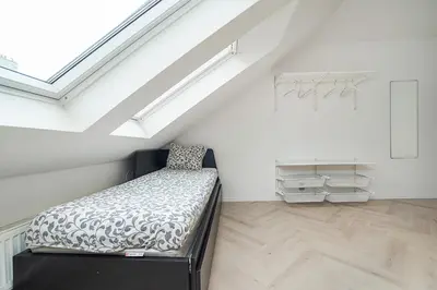 a bedroom with a bed in a attic at Big 4-bedroom flat, terrace with great Vítkov view in Prague