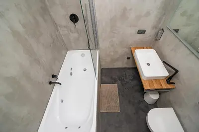 a bathroom with a tub and a toilet and a sink at Big 4-bedroom flat, terrace with great Vítkov view in Prague
