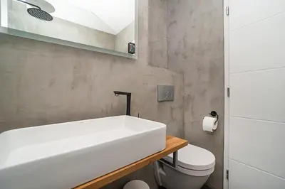 a bathroom with a white sink and a toilet at Big 4-bedroom flat, terrace with great Vítkov view in Prague