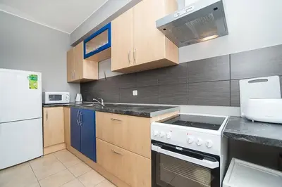 a kitchen with a white stove top oven next to a refrigerator at Great Terrace in Big, Central Flat in Prague