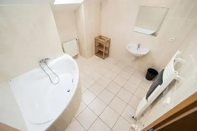 a bathroom with a tub and a toilet and a sink at Great Terrace in Big, Central Flat in Prague