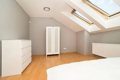 a bedroom with a white bed and a skylight at Great Terrace in Big, Central Flat in Prague