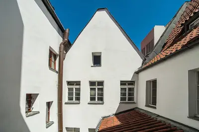 a white building with a pointed roof at Newly renovated 1-bed apartment at Charles Bridge in Prague