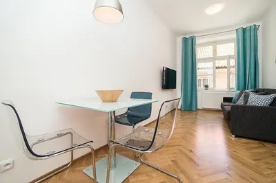a living room with a table and chairs in a room at Newly renovated 1-bed apartment at Charles Bridge in Prague