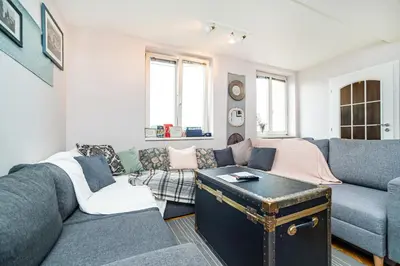 a living room with a couch and a table at Central, Spacious, Modern 5 Bedrm duplex w/Balcony in Prague