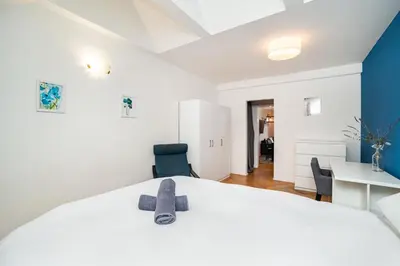 a bedroom with a bed with a stuffed animal on it at Central, Spacious, Modern 5 Bedrm duplex w/Balcony in Prague