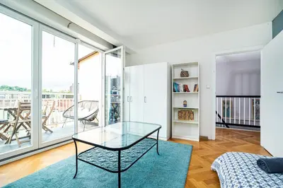 a living room with a glass table and a large window at Central, Spacious, Modern 5 Bedrm duplex w/Balcony in Prague