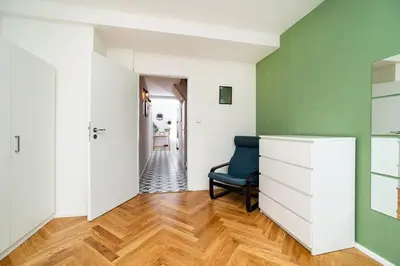 a living room with green walls and a chair at Central, Spacious, Modern 5 Bedrm duplex w/Balcony in Prague