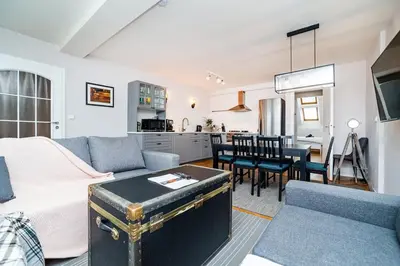 a living room with a couch and a dining room at Central, Spacious, Modern 5 Bedrm duplex w/Balcony in Prague