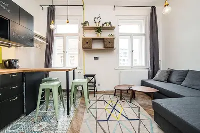 a living room with a couch and a table at Central designer studio by beautiful park & church in Prague