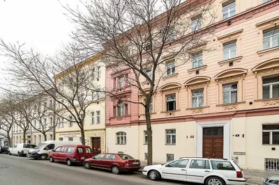 a row of cars parked in front of a building at Central designer studio by beautiful park & church in Prague