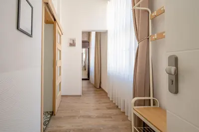a hallway with white walls and wooden flooring at Premium Wenceslas Square Apartments in Prague