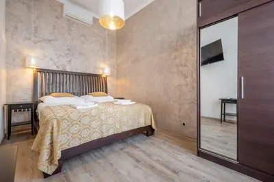 a bedroom with a bed and a sliding glass door at Premium Wenceslas Square Apartments in Prague