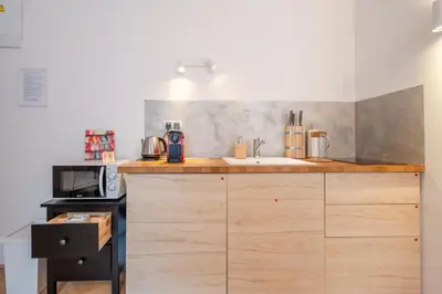 a kitchen with a counter with a sink and a microwave at Premium Wenceslas Square Apartments in Prague