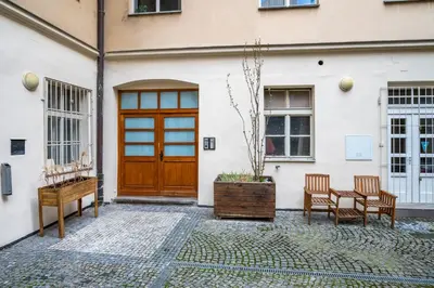 a house with a wooden door and two chairs at Premium Wenceslas Square Apartments in Prague