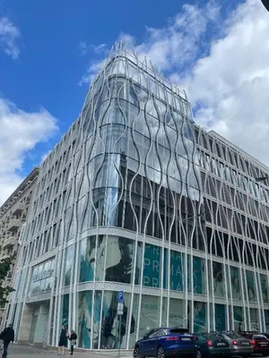 a glass building with people walking in front of it at Premium Wenceslas Square Apartments in Prague