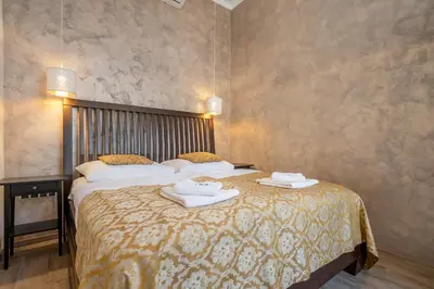 a bedroom with a large bed with towels on it at Premium Wenceslas Square Apartments in Prague