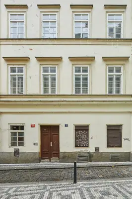 a building with two doors and a building with graffiti on it at Prague Days - Studio in the Heart of Prague near Astronomical Clock in Prague