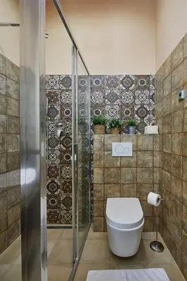 a bathroom with a toilet and a glass shower at Prague Days - Studio in the Heart of Prague near Astronomical Clock in Prague