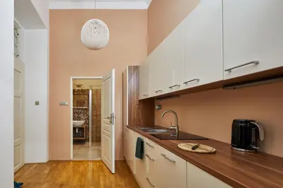 a kitchen with white cabinets and a sink at Prague Days - Studio in the Heart of Prague near Astronomical Clock in Prague