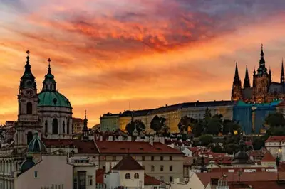 a view of the city at sunset at Andel Studio with terrace in Prague