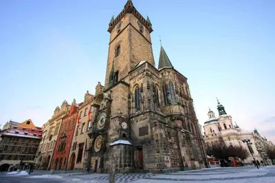 an old building with a tower with clocks on it at Andel Studio with terrace in Prague