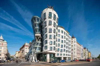 a tall white building with a glass dome at Andel Studio with terrace in Prague