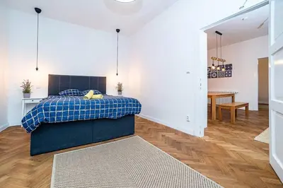 a bedroom with a bed with a blue plaid blanket at Elegant, modern, 2-bed flat by Museum of Prague in Prague