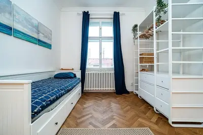 a bedroom with a bed and a window at Elegant, modern, 2-bed flat by Museum of Prague in Prague