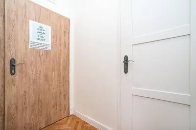 a door with a sign on it next to a room at Elegant, modern, 2-bed flat by Museum of Prague in Prague