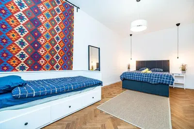 a bedroom with two beds and a colorful wall at Elegant, modern, 2-bed flat by Museum of Prague in Prague