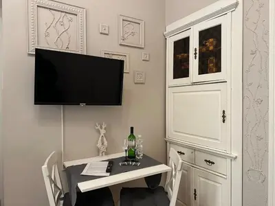 a room with a table with a television on a wall at Stylový byt v srdci Prahy in Prague