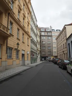 an empty street in a city with buildings at Stylový byt v srdci Prahy in Prague