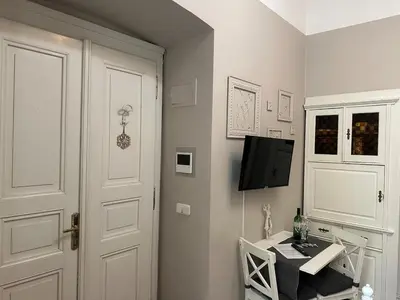a room with a desk and a tv and a door at Stylový byt v srdci Prahy in Prague
