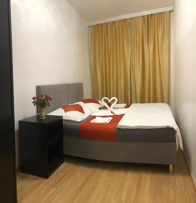a bedroom with a bed with a red and white blanket at Lena Apartment in Prague