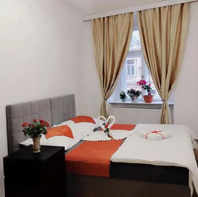 a bedroom with two beds and a window at Lena Apartment in Prague