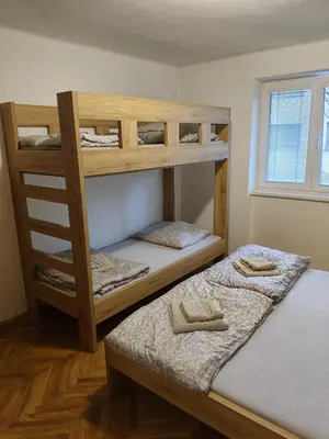 two bunk beds in a room with a window at Apartmán Matěj in Poděbrady