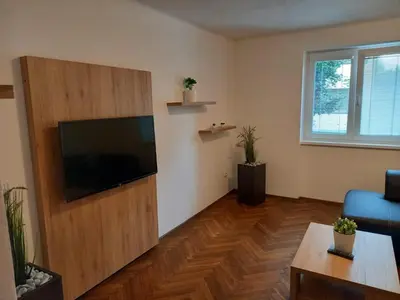 a living room with a flat screen tv on a wall at Apartmán Matěj in Poděbrady