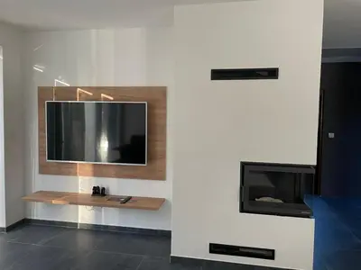 a living room with a tv and a fireplace at Vilka Petra pod Bezdězem in Weisswasser in Böhmen