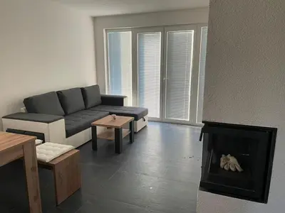 a living room with a couch and a fireplace at Vilka Petra pod Bezdězem in Weisswasser in Böhmen
