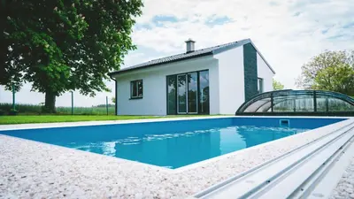 a villa with a swimming pool in front of a house at Vilka Petra pod Bezdězem in Weisswasser in Böhmen