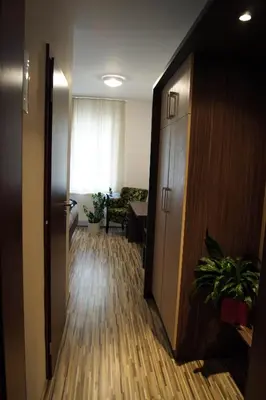 a hallway of an office with a room with a desk and a door at Penzion Ranch in Hořovice