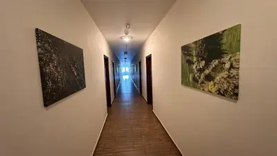 a hallway with three paintings on the walls at Penzion Ranch in Hořovice